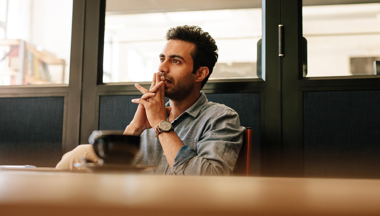 Man thinking over a coffee