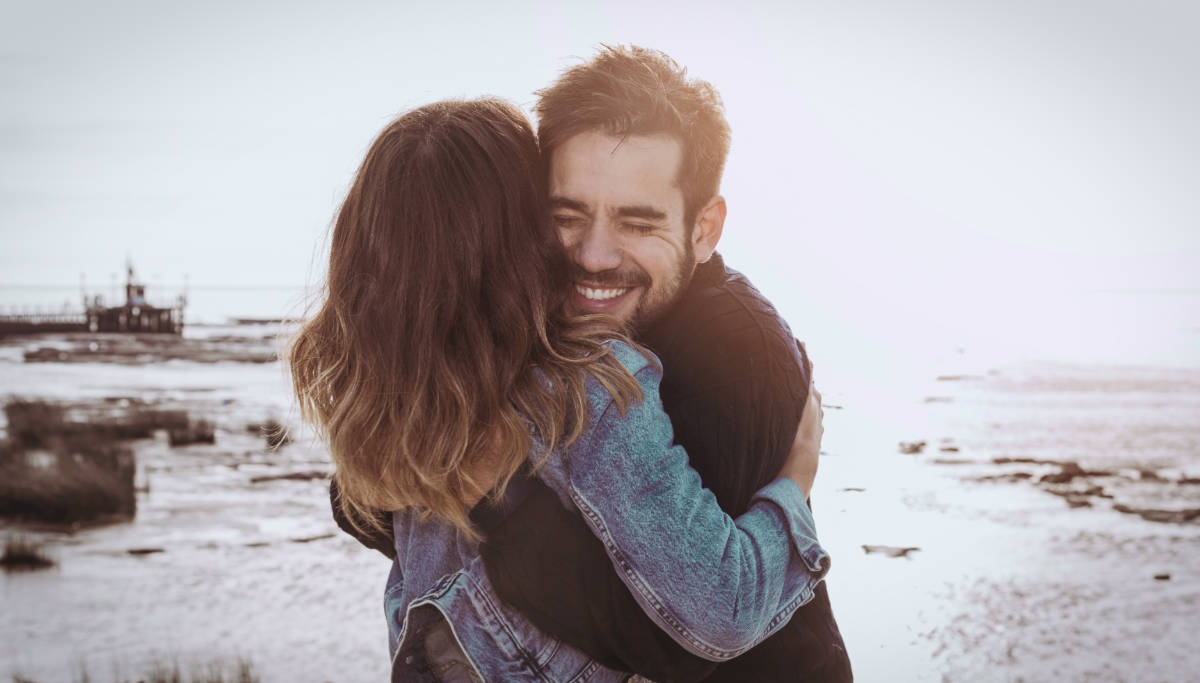 Young couple in an embrace at the beach