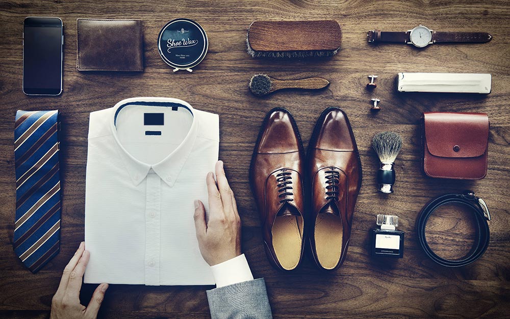 Neatly organised items and clothing on a wooden table