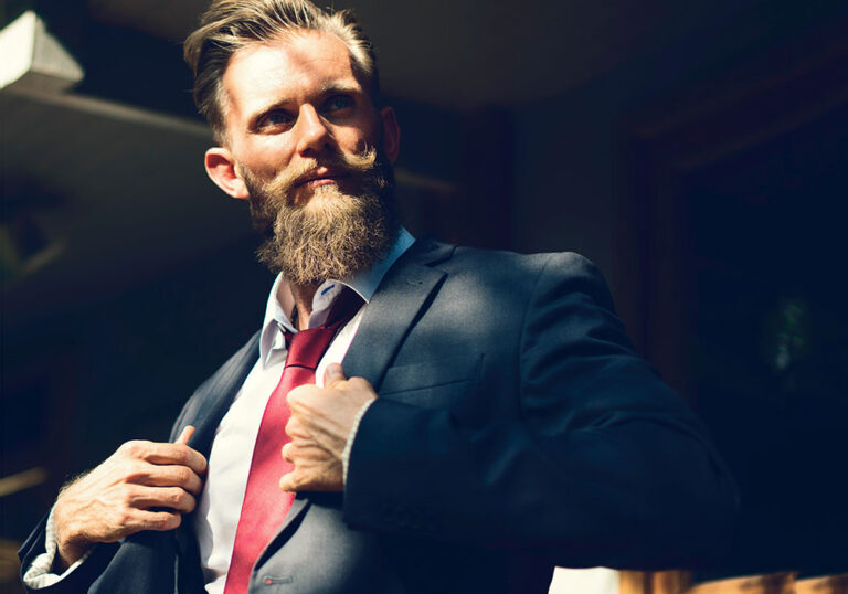 Arrogant looking man holding his suit lapels proudly