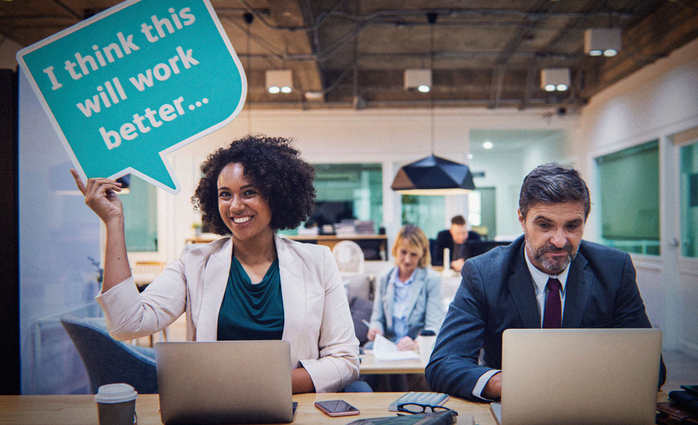 Confident Woman holds sign up at her desk