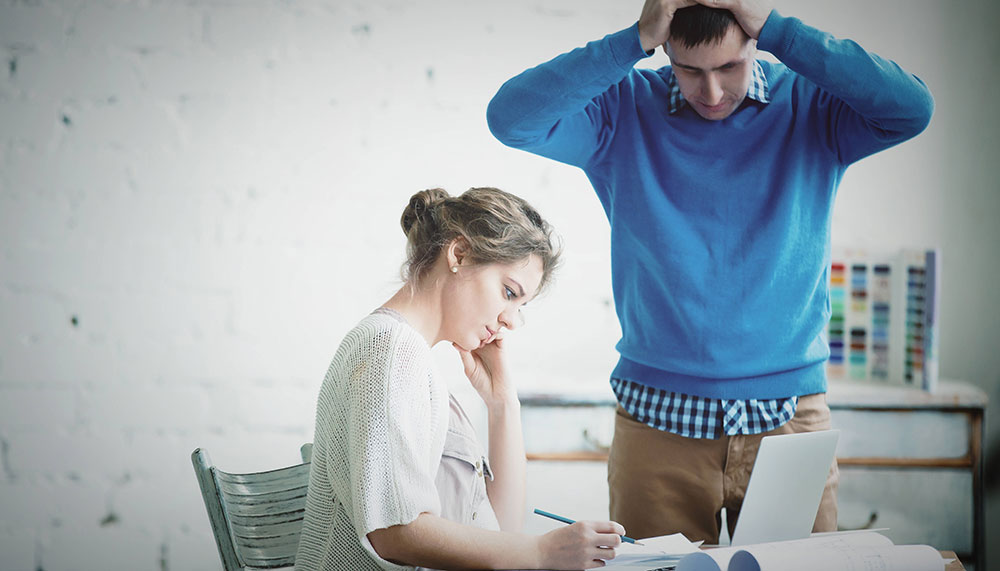 Woman being critical of another collegue's work